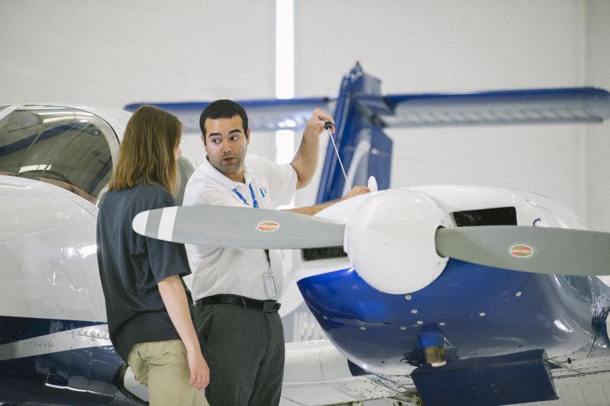 Teacher showing student an airplane